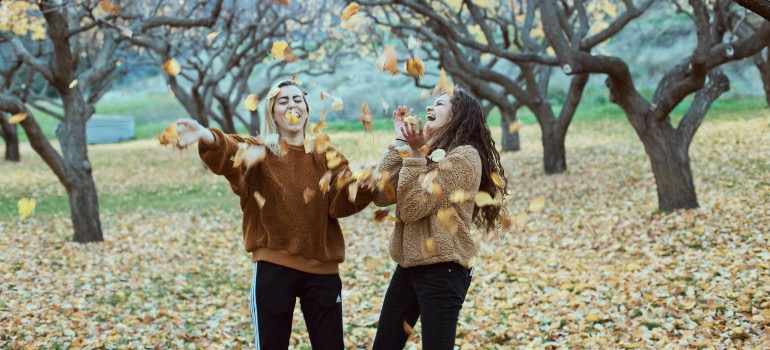 Two girls having fun during the fall